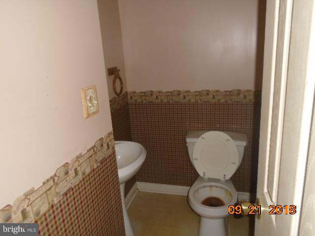 432 Salisbury Road Edgewater, MD 21037 - Photo 6 of 8 a bathroom with a toilet and a mirror