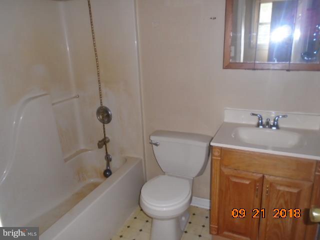 432 Salisbury Road Edgewater, MD 21037 - Photo 7 of 8 a bathroom with a sink a toilet and shower