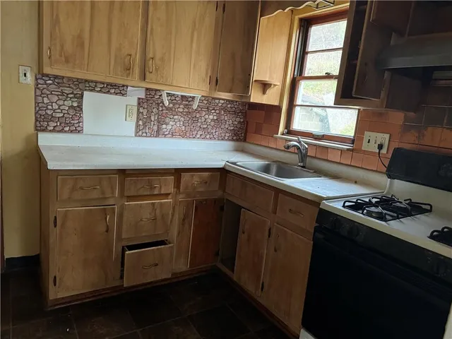 a kitchen with a sink stove and cabinets