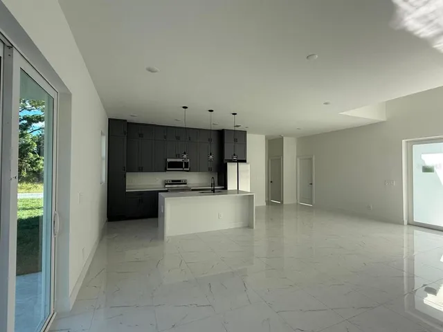 a kitchen with a refrigerator and a sink