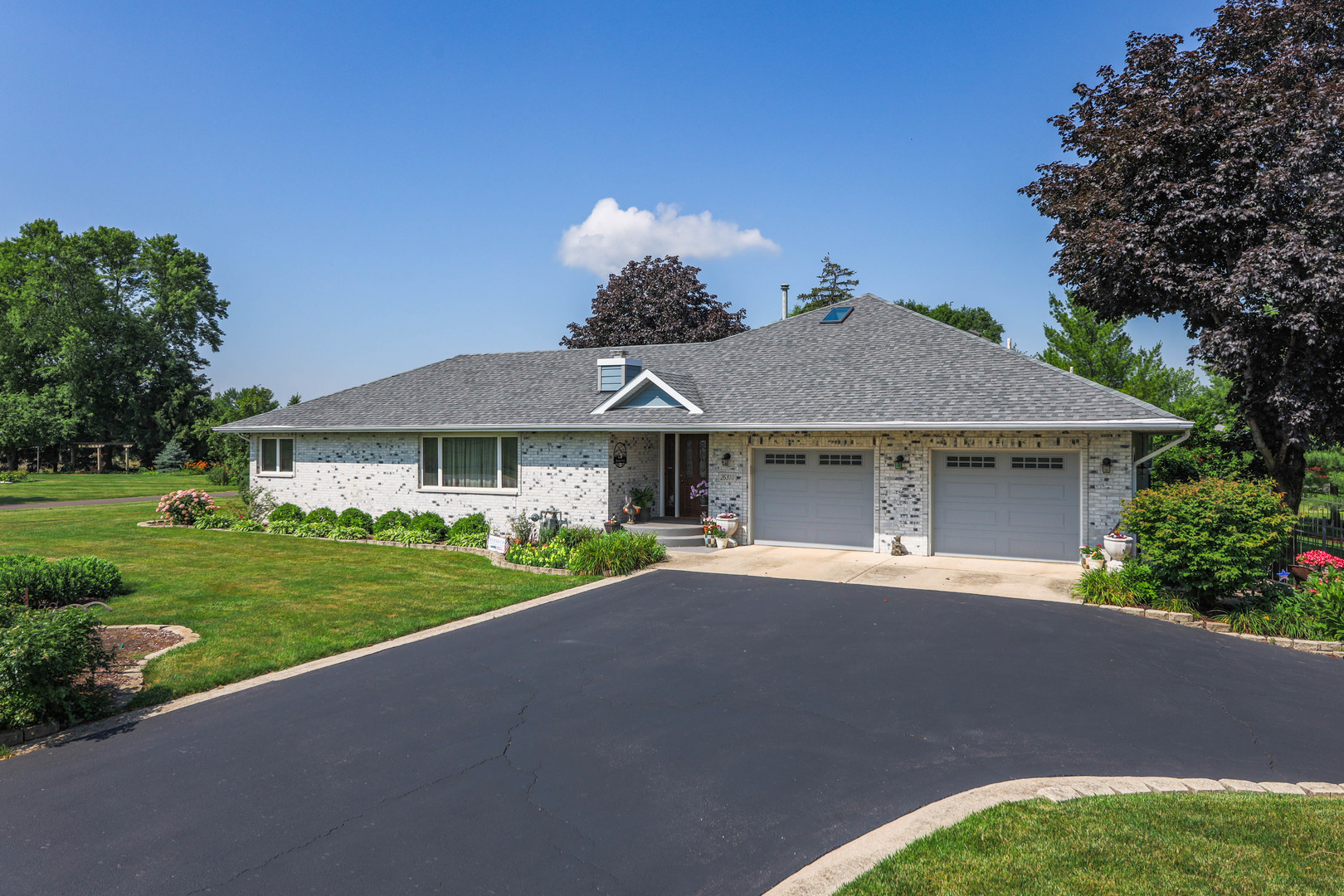 26310 South McKinley Woods Road Channahon, IL 60410 - Photo 1 of 49 a front view of a house with a garden