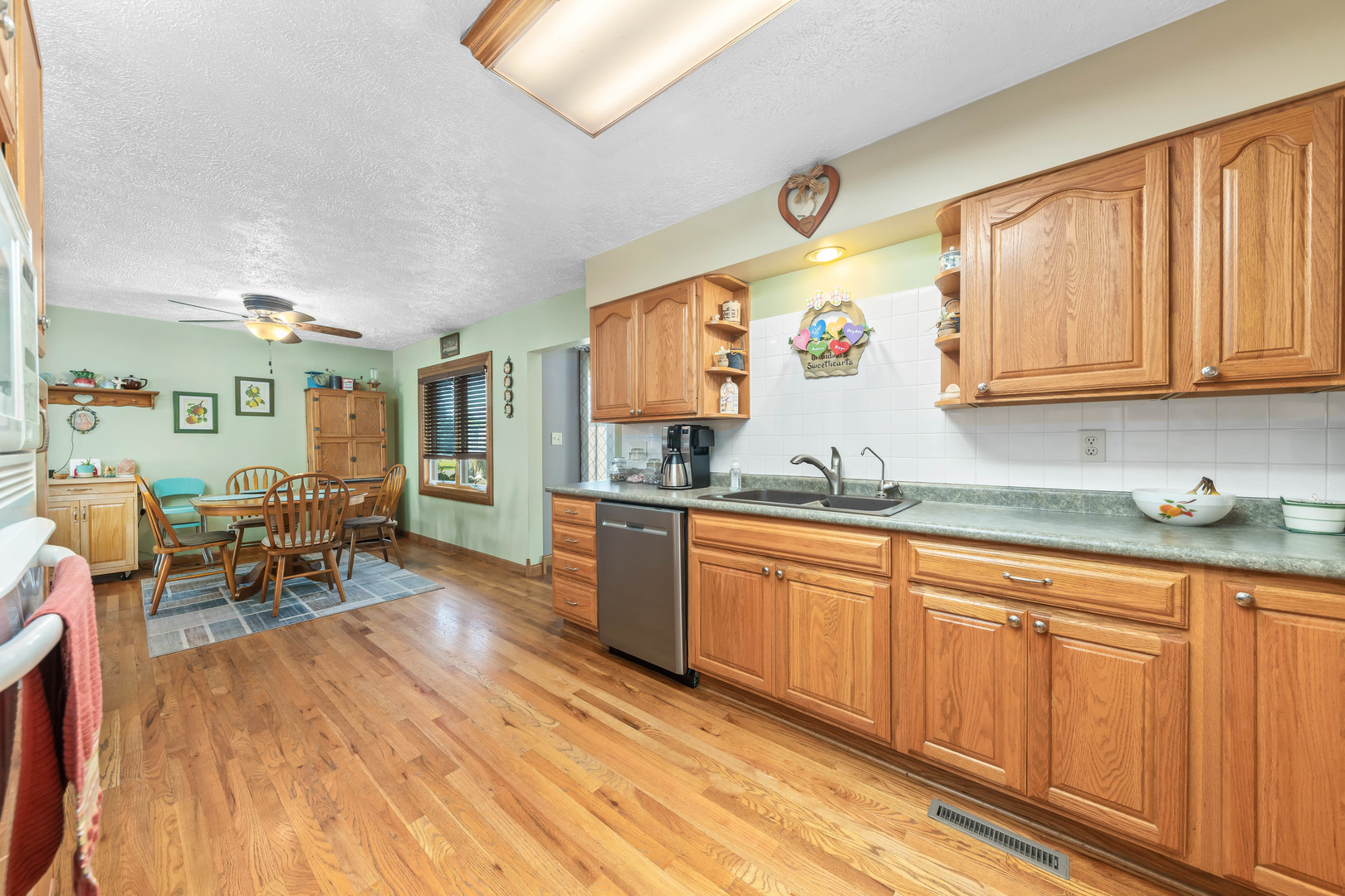 26310 South McKinley Woods Road Channahon, IL 60410 - Photo 12 of 49 a kitchen with stainless steel appliances granite countertop wooden cabinets a sink and dishwasher