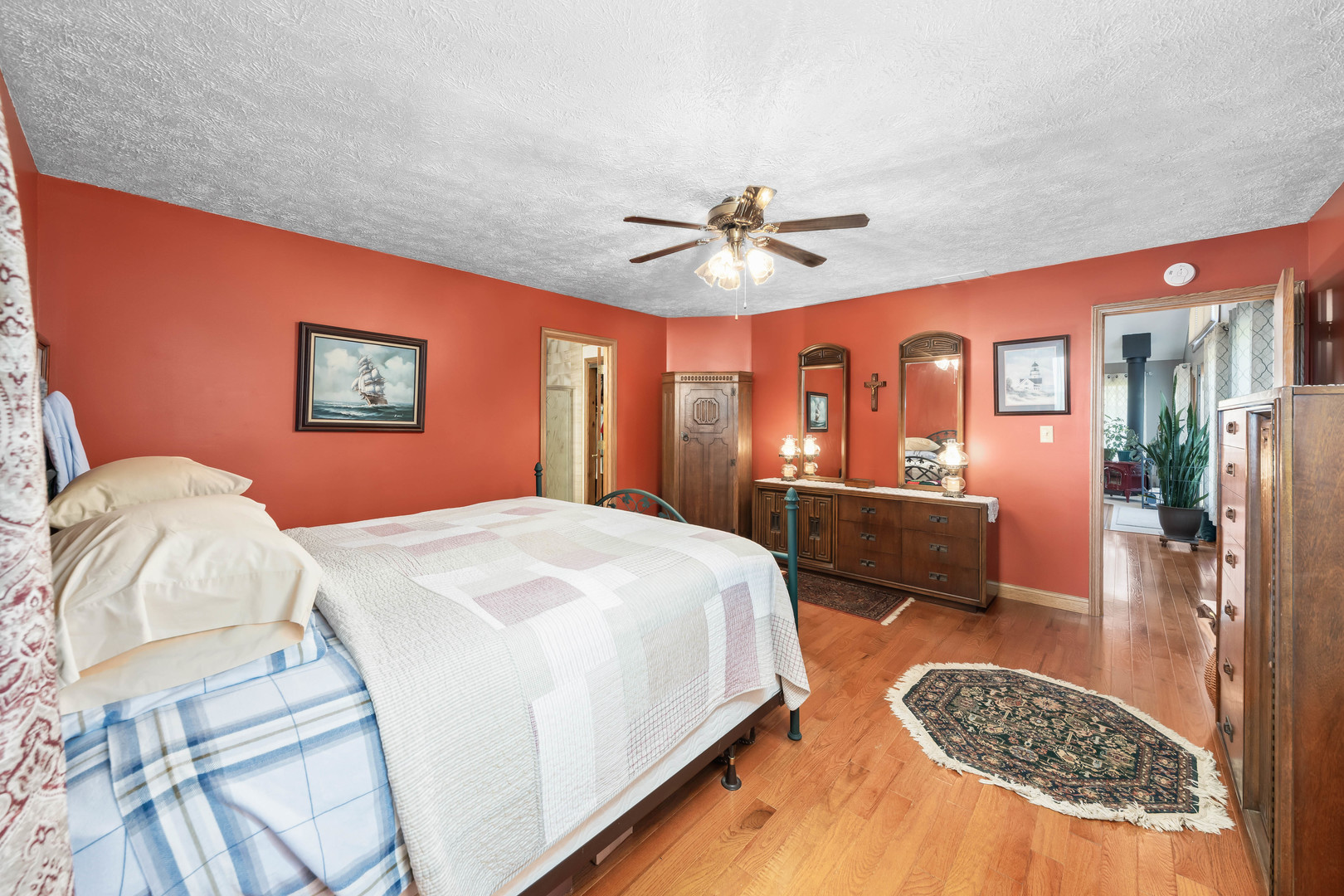 26310 South McKinley Woods Road Channahon, IL 60410 - Photo 20 of 49 a spacious bedroom with a bed a dresser and potted plant
