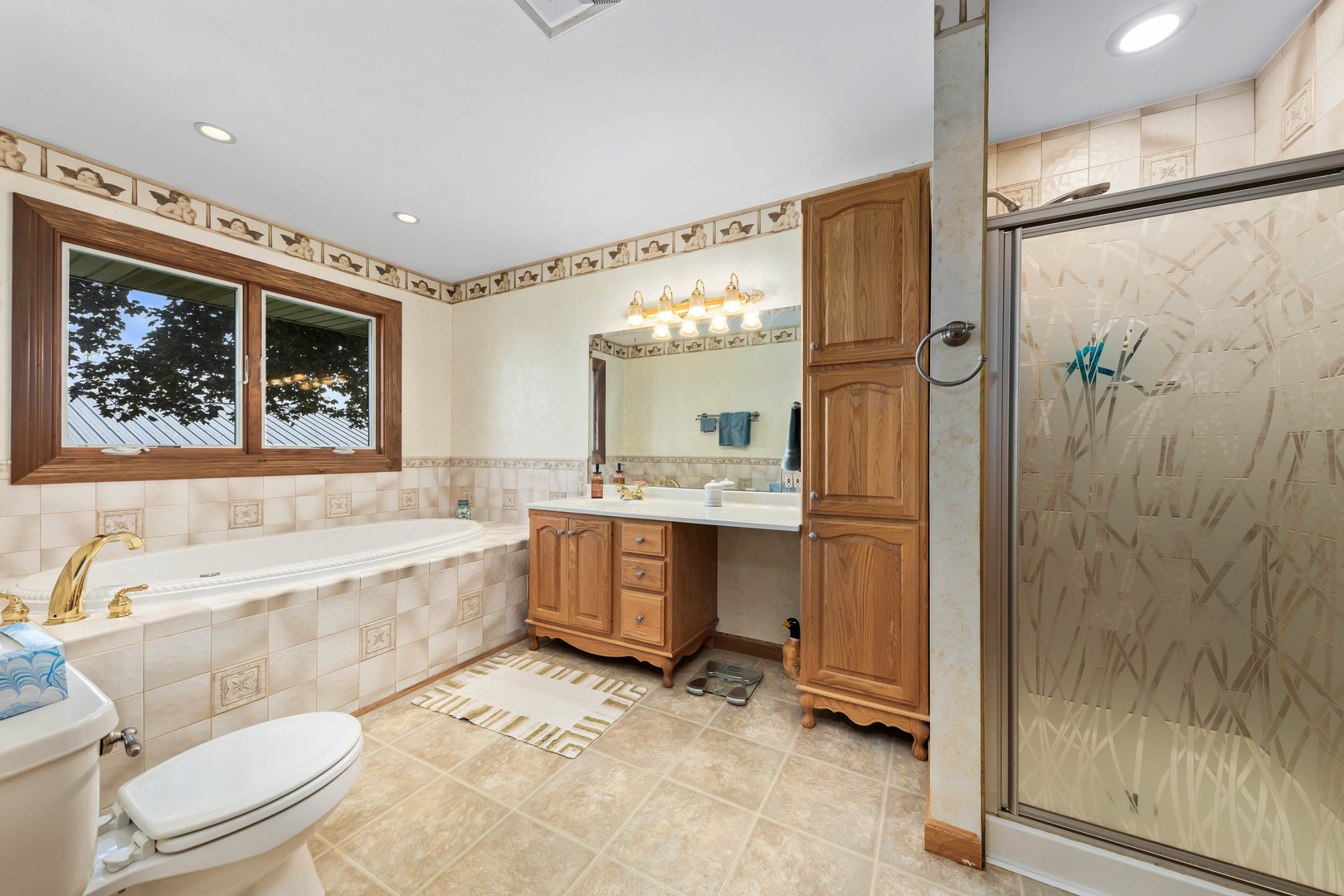26310 South McKinley Woods Road Channahon, IL 60410 - Photo 23 of 49 a bathroom with a granite countertop tub toilet a sink and glass door