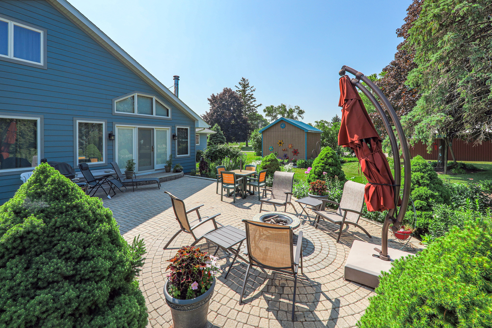 26310 South McKinley Woods Road Channahon, IL 60410 - Photo 36 of 49 a view of a patio with table and chairs potted plants and large tree