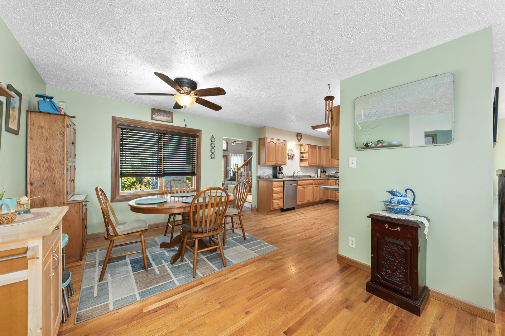 26310 South McKinley Woods Road Channahon, IL 60410 - Photo 7 of 49 a dining room with furniture a chandelier and wooden floor