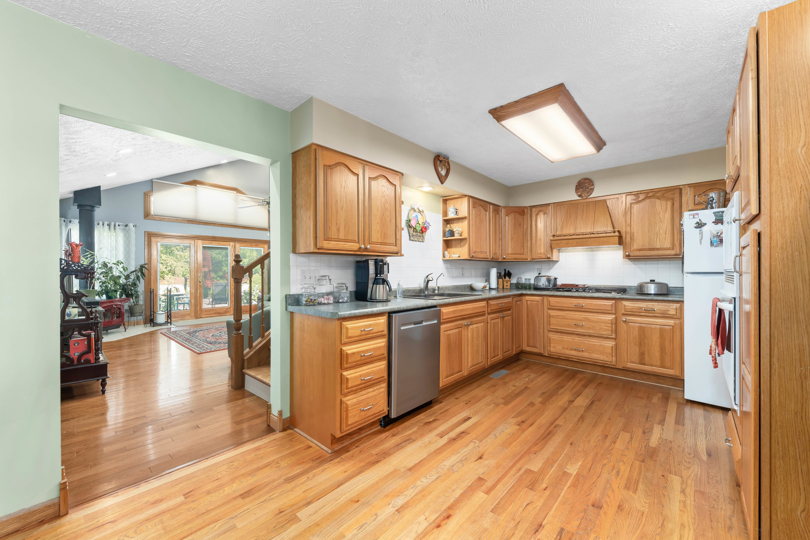 26310 South McKinley Woods Road Channahon, IL 60410 - Photo 8 of 49 a large kitchen with a lot of counter space and wooden floor