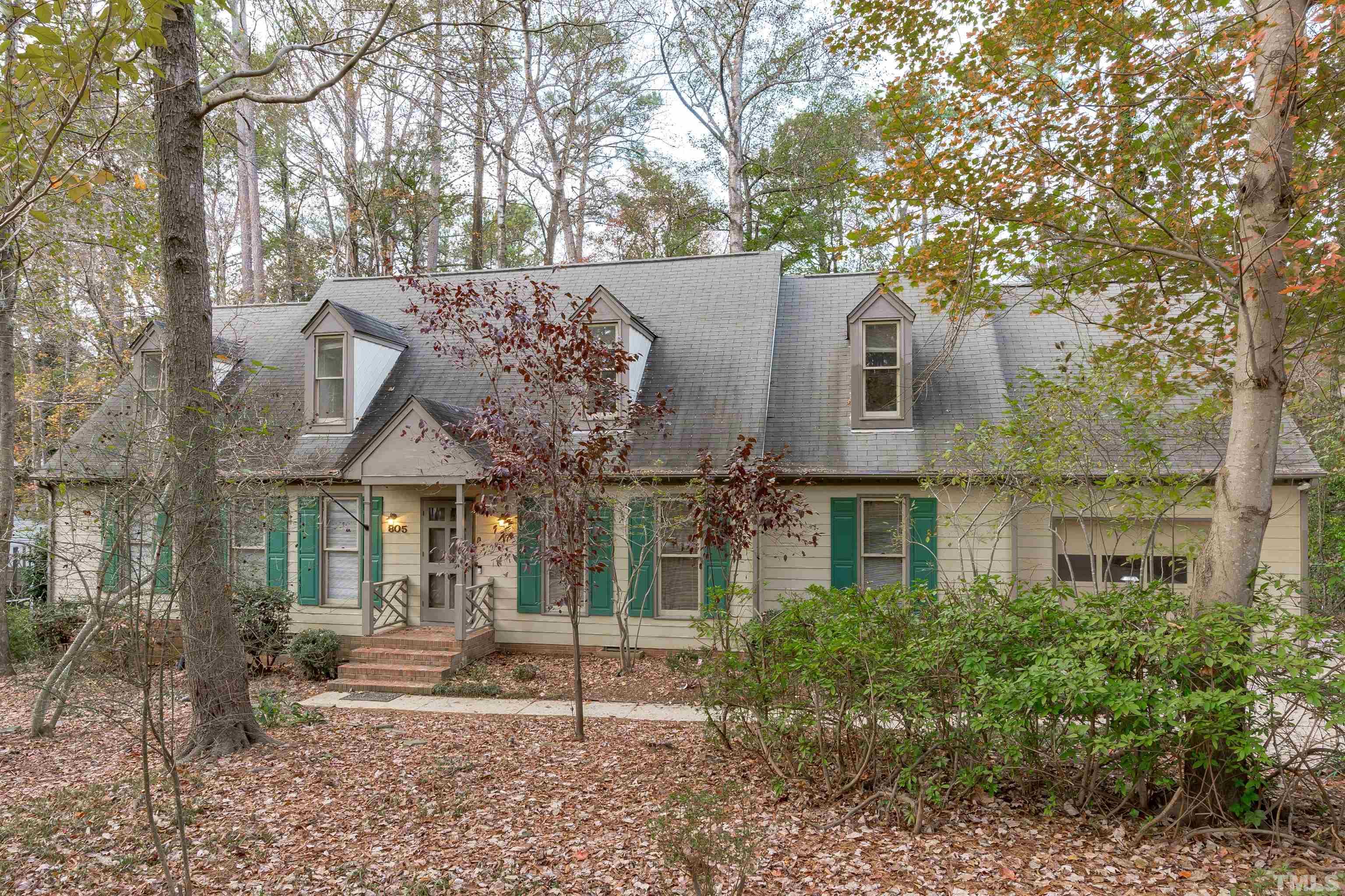 front view of a house with a tree