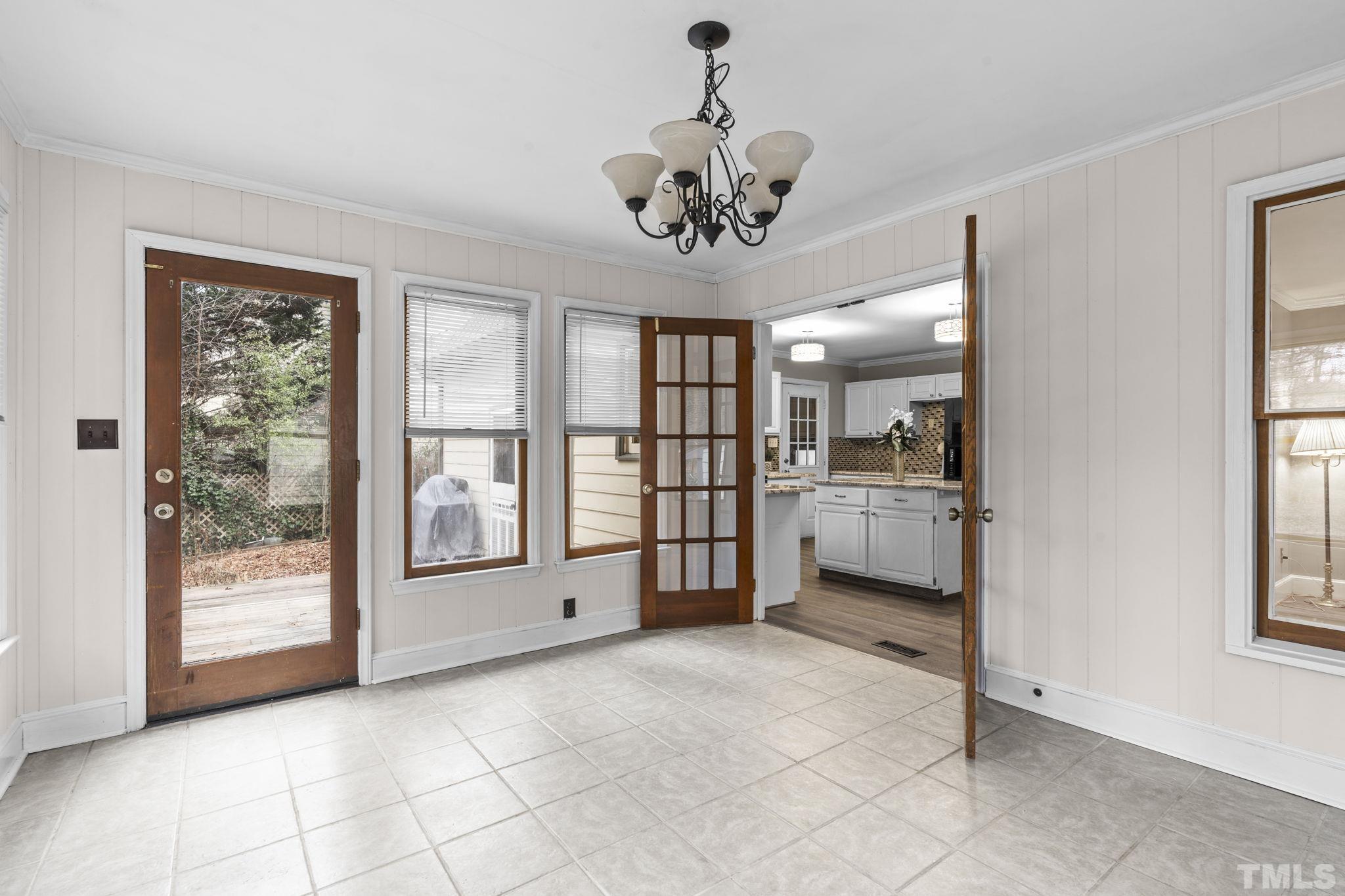 805 Van Thomas Drive Raleigh, NC 27615 - Photo 11 of 38 a view of a big room with windows and chandelier