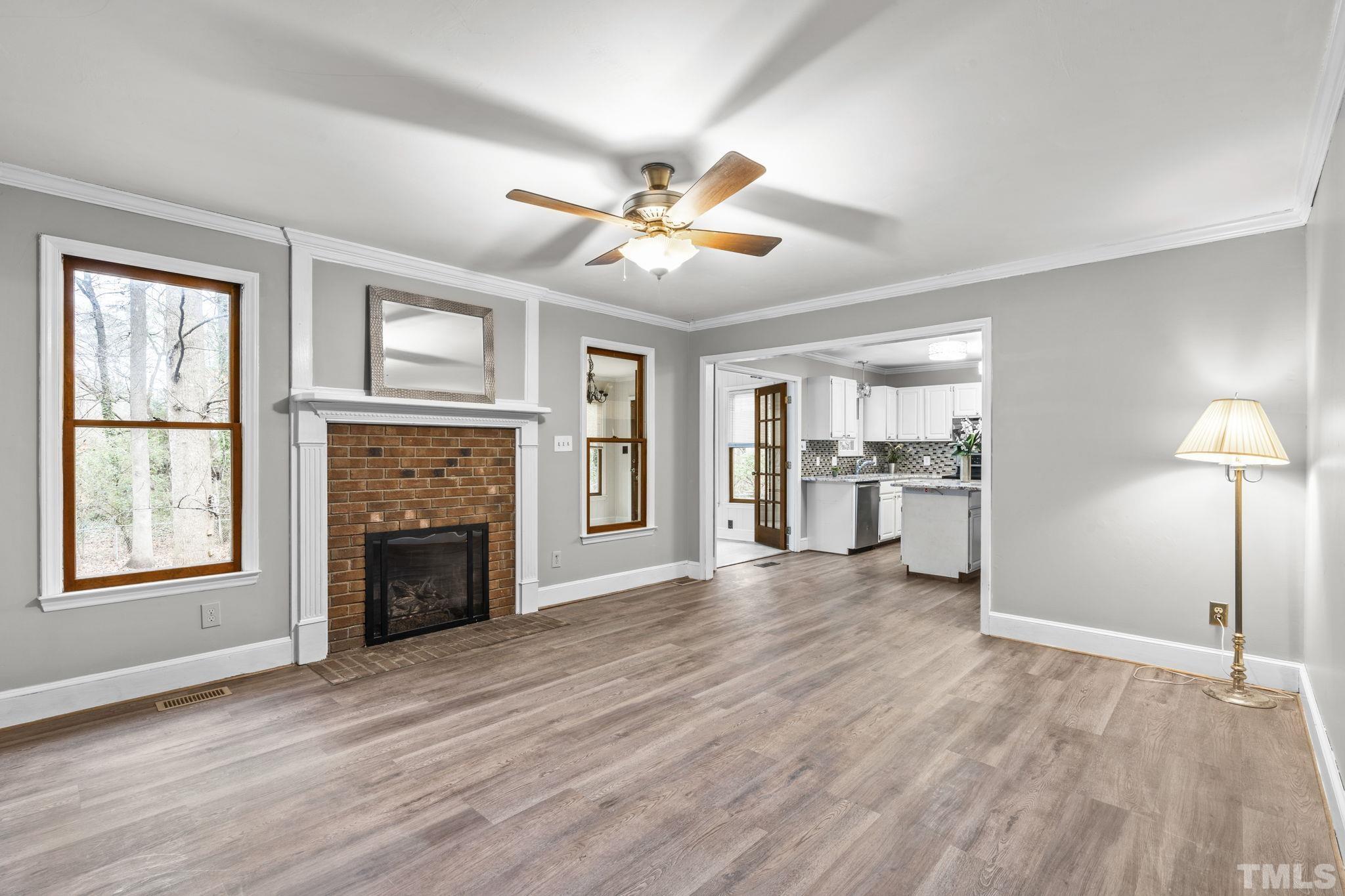 805 Van Thomas Drive Raleigh, NC 27615 - Photo 13 of 38 a view of an empty room with window and wooden floor