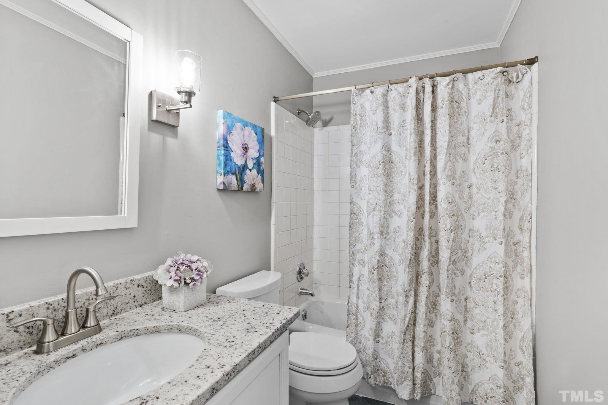 805 Van Thomas Drive Raleigh, NC 27615 - Photo 22 of 38 a bathroom with a granite countertop sink and a mirror
