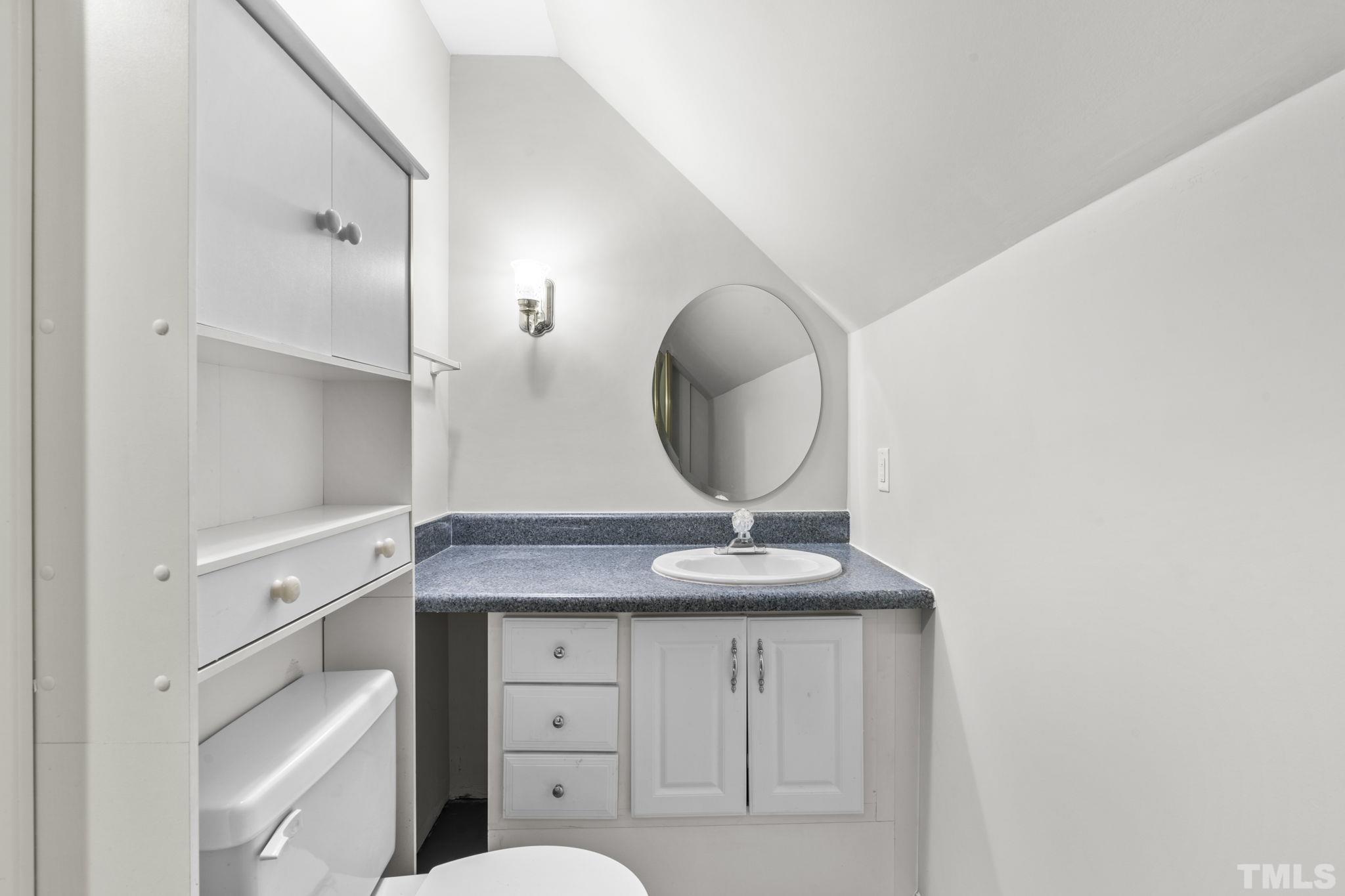 805 Van Thomas Drive Raleigh, NC 27615 - Photo 25 of 38 a bathroom with a granite countertop sink a mirror and vanity
