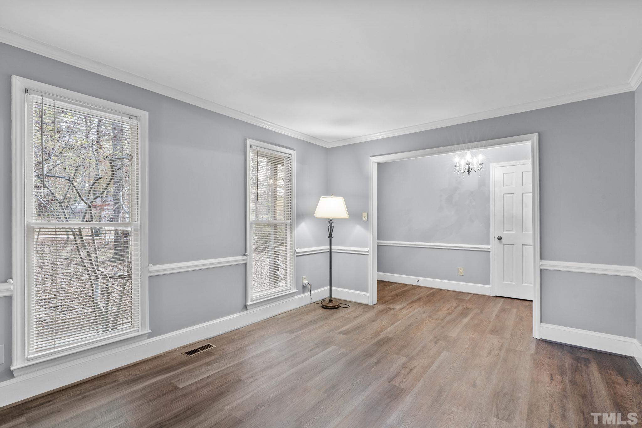 805 Van Thomas Drive Raleigh, NC 27615 - Photo 4 of 38 a view of empty room with wooden floor and fan