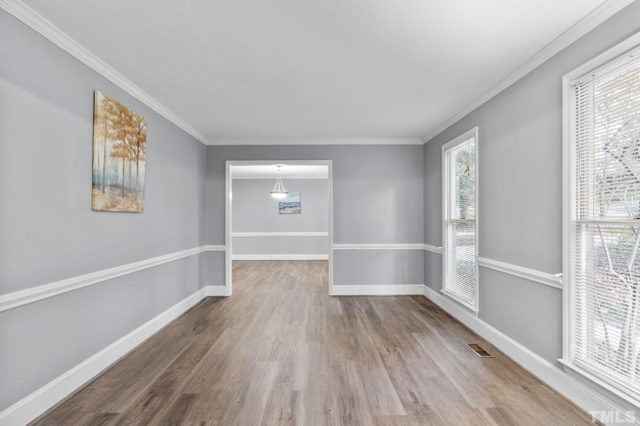 805 Van Thomas Drive Raleigh, NC 27615 - Photo 5 of 38 a view of empty room with wooden floor and fan