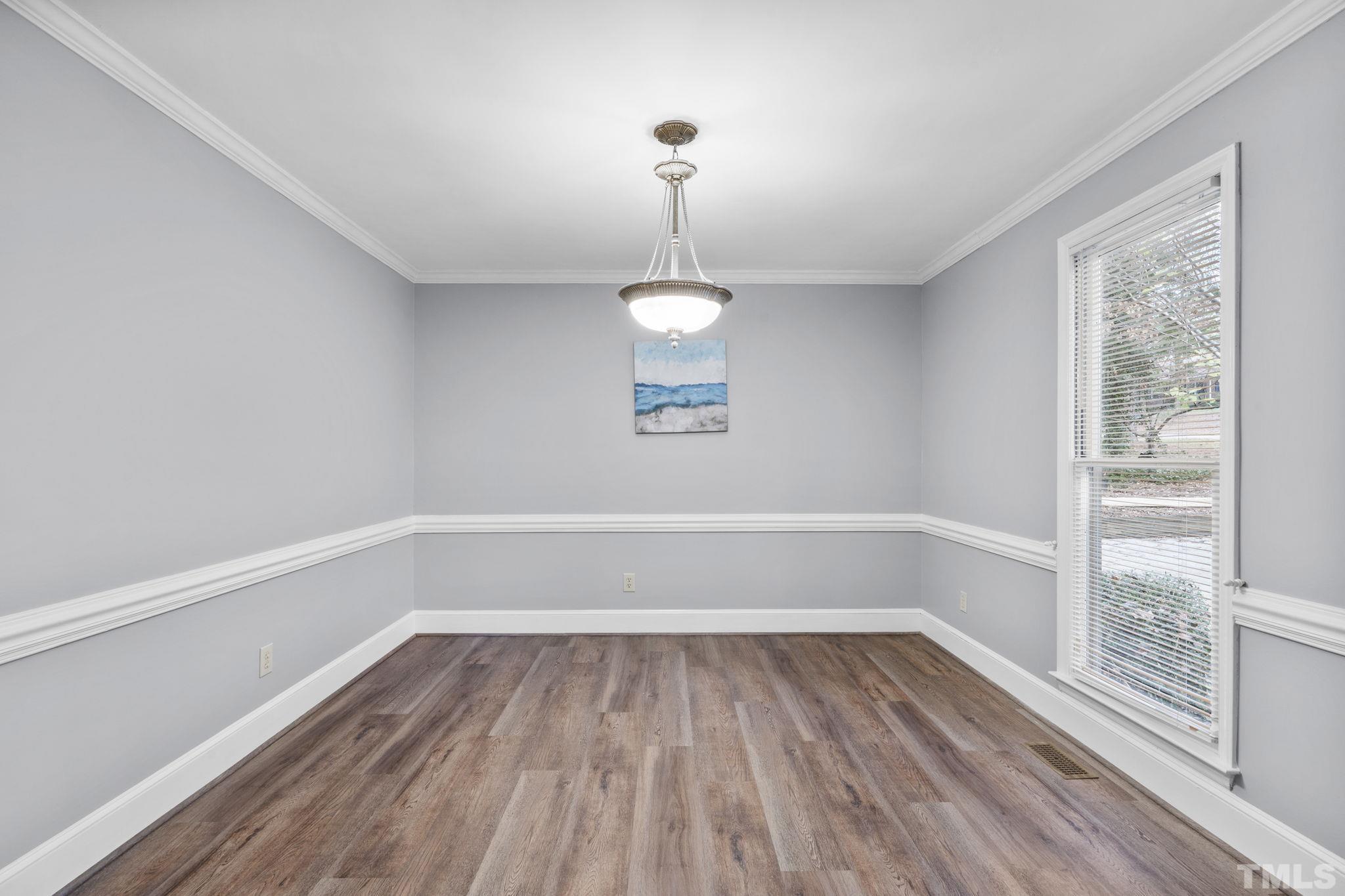 805 Van Thomas Drive Raleigh, NC 27615 - Photo 7 of 38 a view of a room with wooden floor cabinets and a window