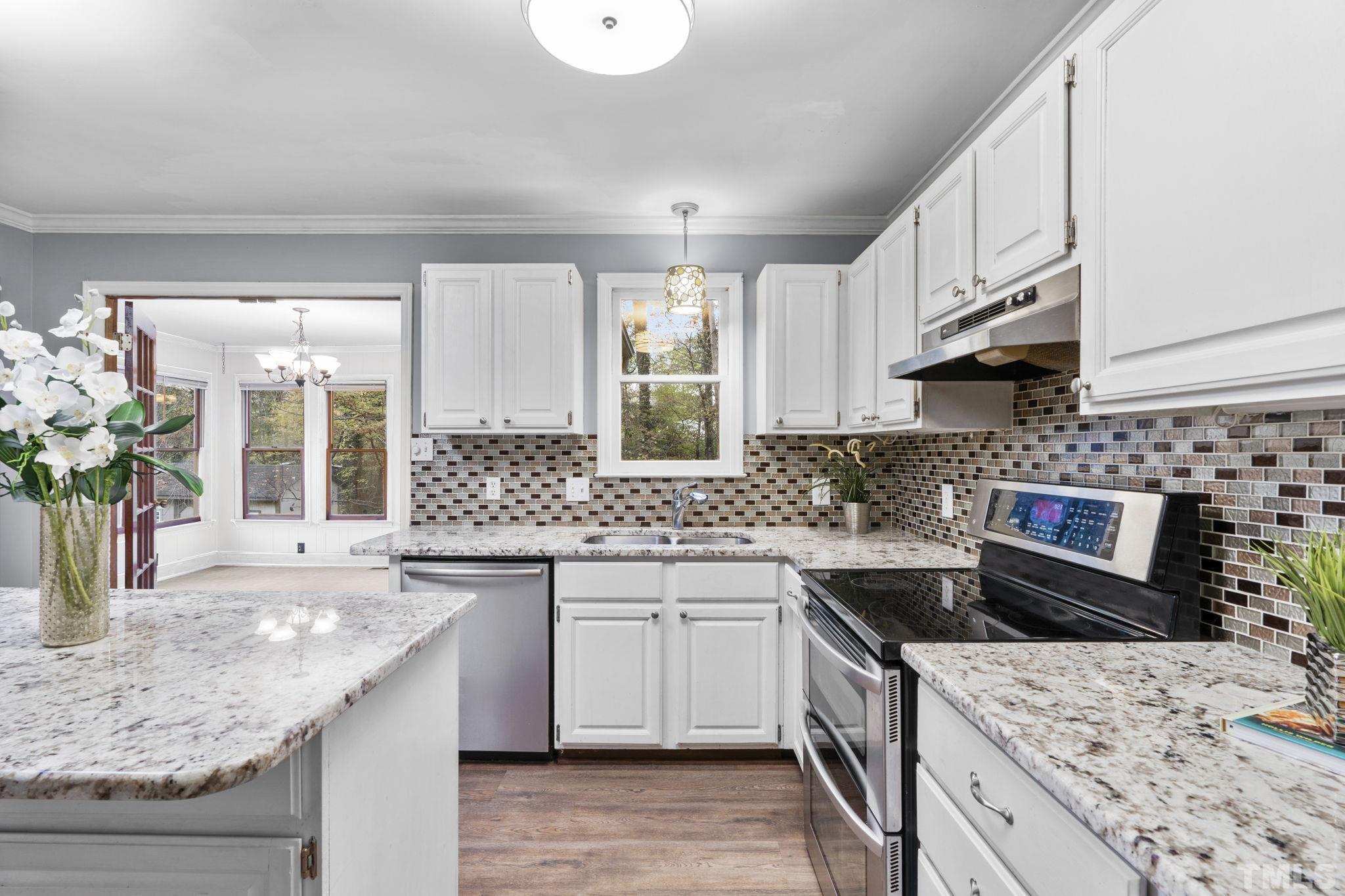 805 Van Thomas Drive Raleigh, NC 27615 - Photo 9 of 38 a kitchen with a sink stove and refrigerator