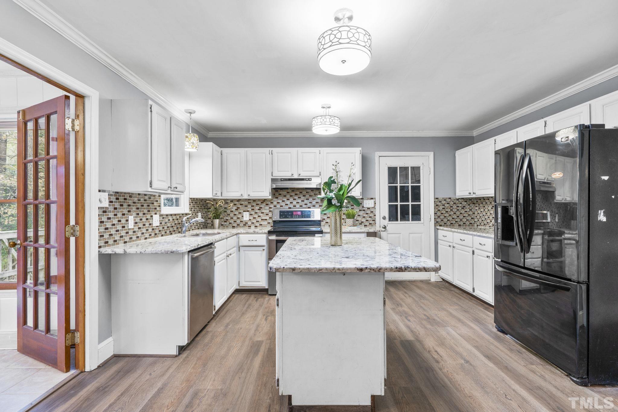 805 Van Thomas Drive Raleigh, NC 27615 - Photo 10 of 38 a kitchen with a refrigerator sink and cabinets