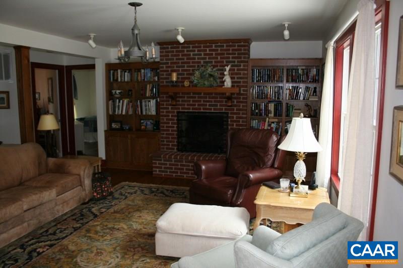 429 Beautiful Run Road Rochelle, VA 22738 - Photo 5 of 30 a living room with furniture a lamp and a fireplace