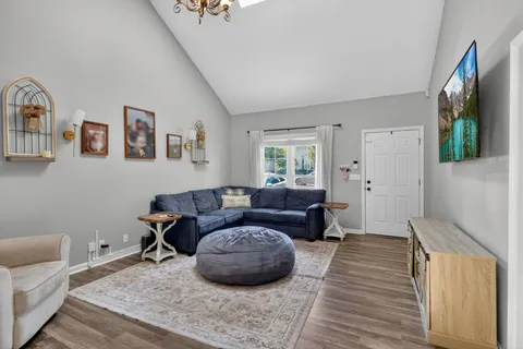 a living room with furniture and a wooden floor