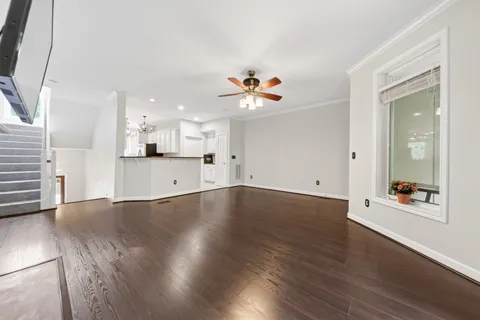 a kitchen with granite countertop white cabinets and stainless steel appliances