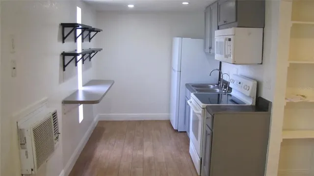 a kitchen with stainless steel appliances a refrigerator and a stove top oven