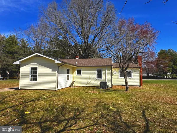 a house that has a tree in front of the house