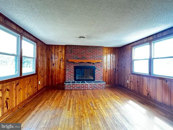 wooden floor in an empty room with a fireplace