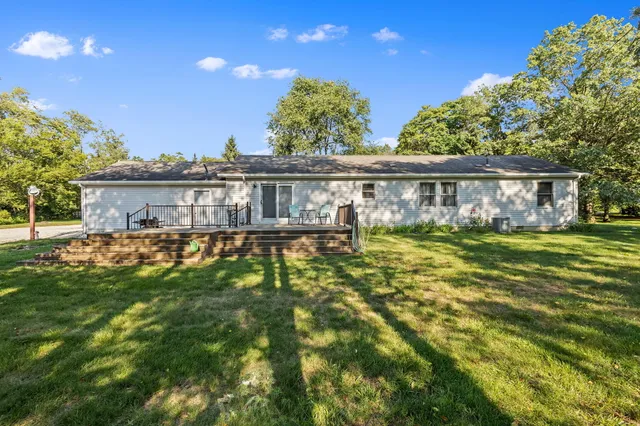 a view of a house with a yard and garage