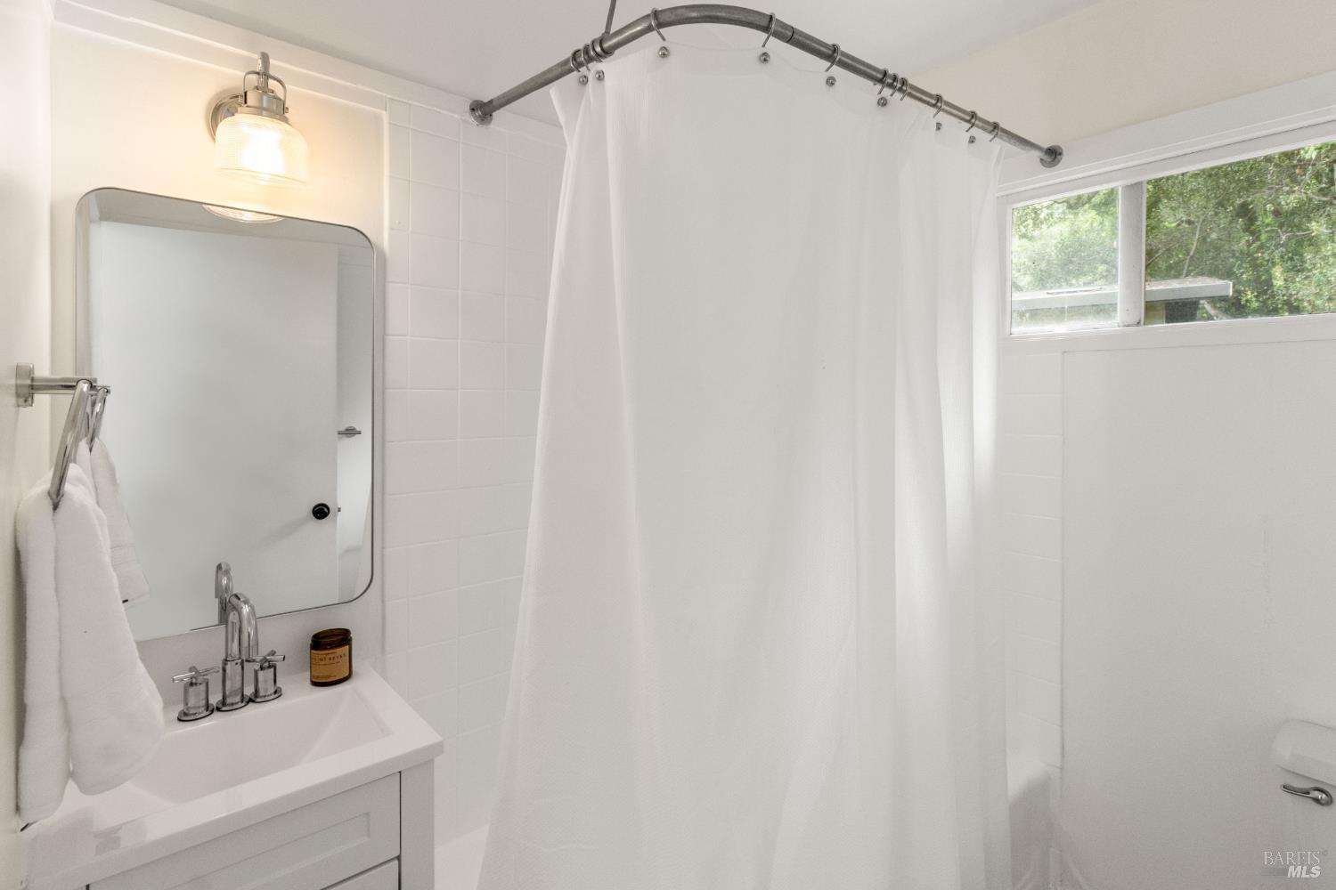 206 Bolinas Road Fairfax, CA 94930 - Photo 20 of 43 Upstairs bathroom with new mirror, light, vanity/sink/faucet, towel racks and shower head.
