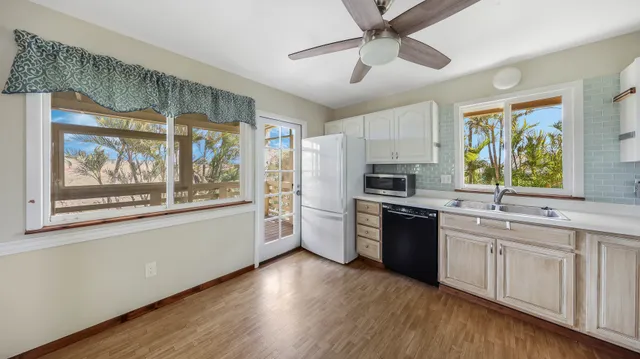 a living room with furniture wooden floor and a window