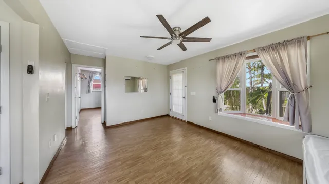 a kitchen with a wooden floor and white appliances