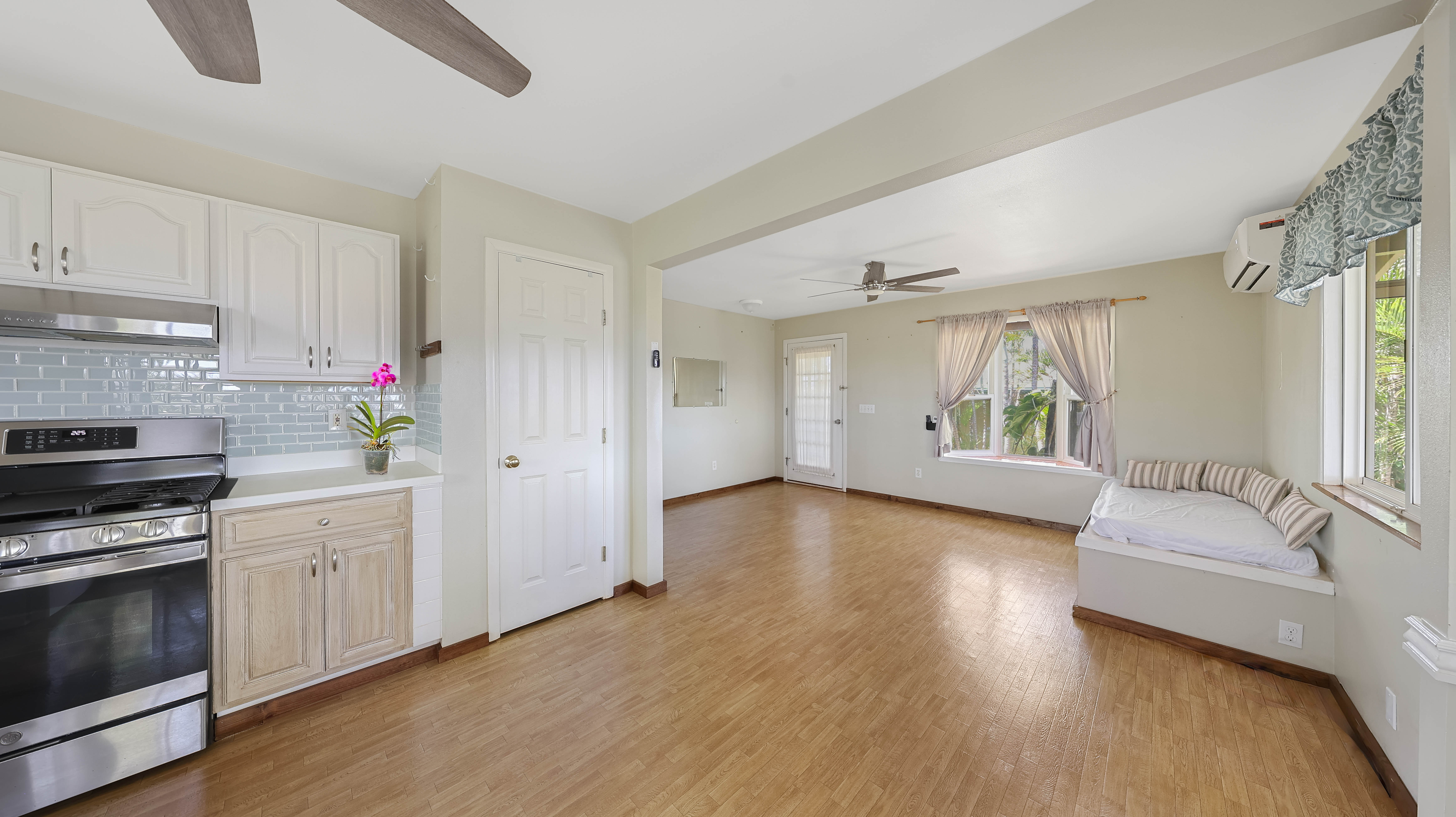 5060 Alii Road Hanapepe, HI 96716 - Photo 16 of 30 a kitchen with a wooden floor and white appliances