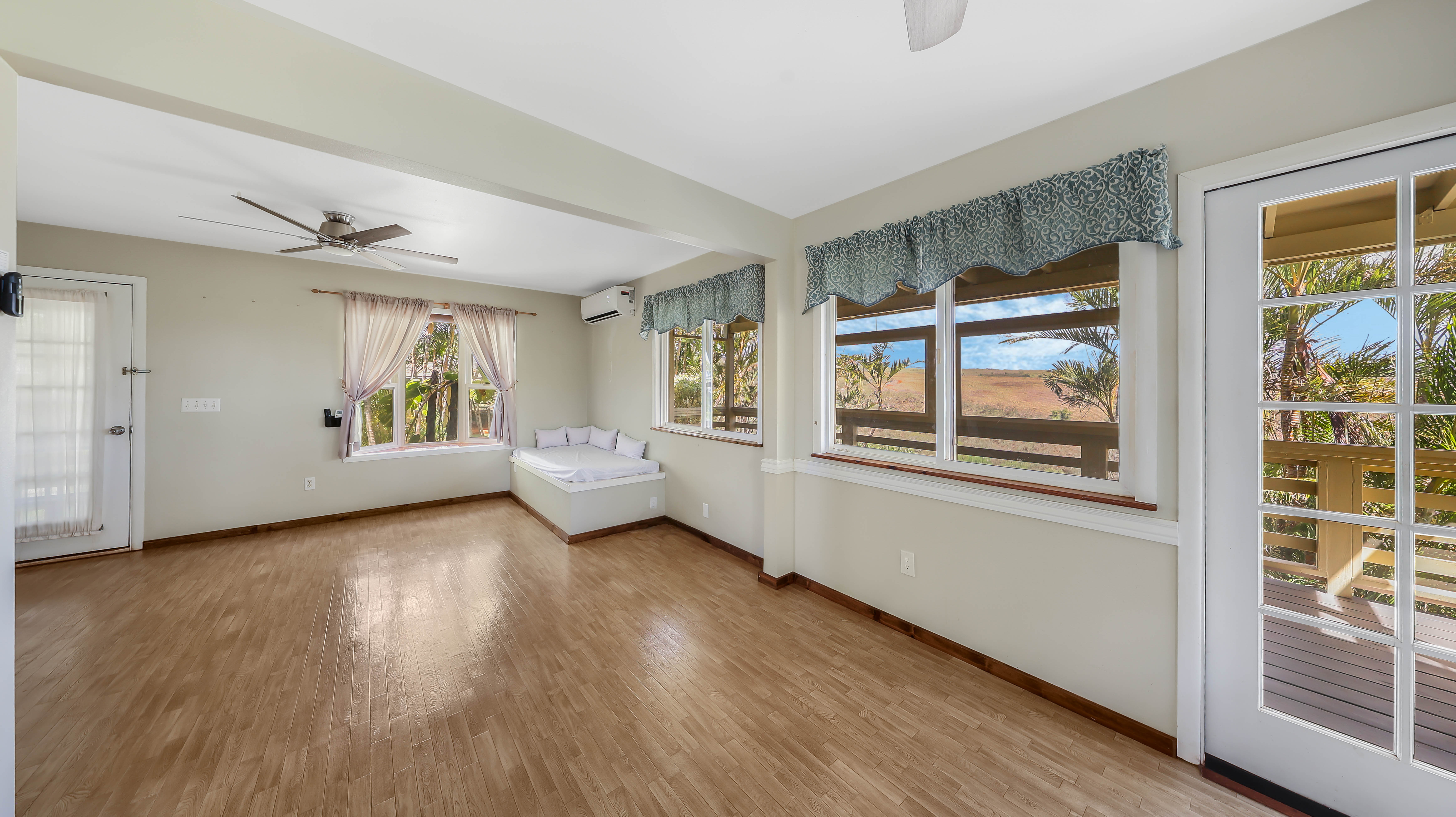 5060 Alii Road Hanapepe, HI 96716 - Photo 17 of 30 a view of a big room with wooden floor and windows