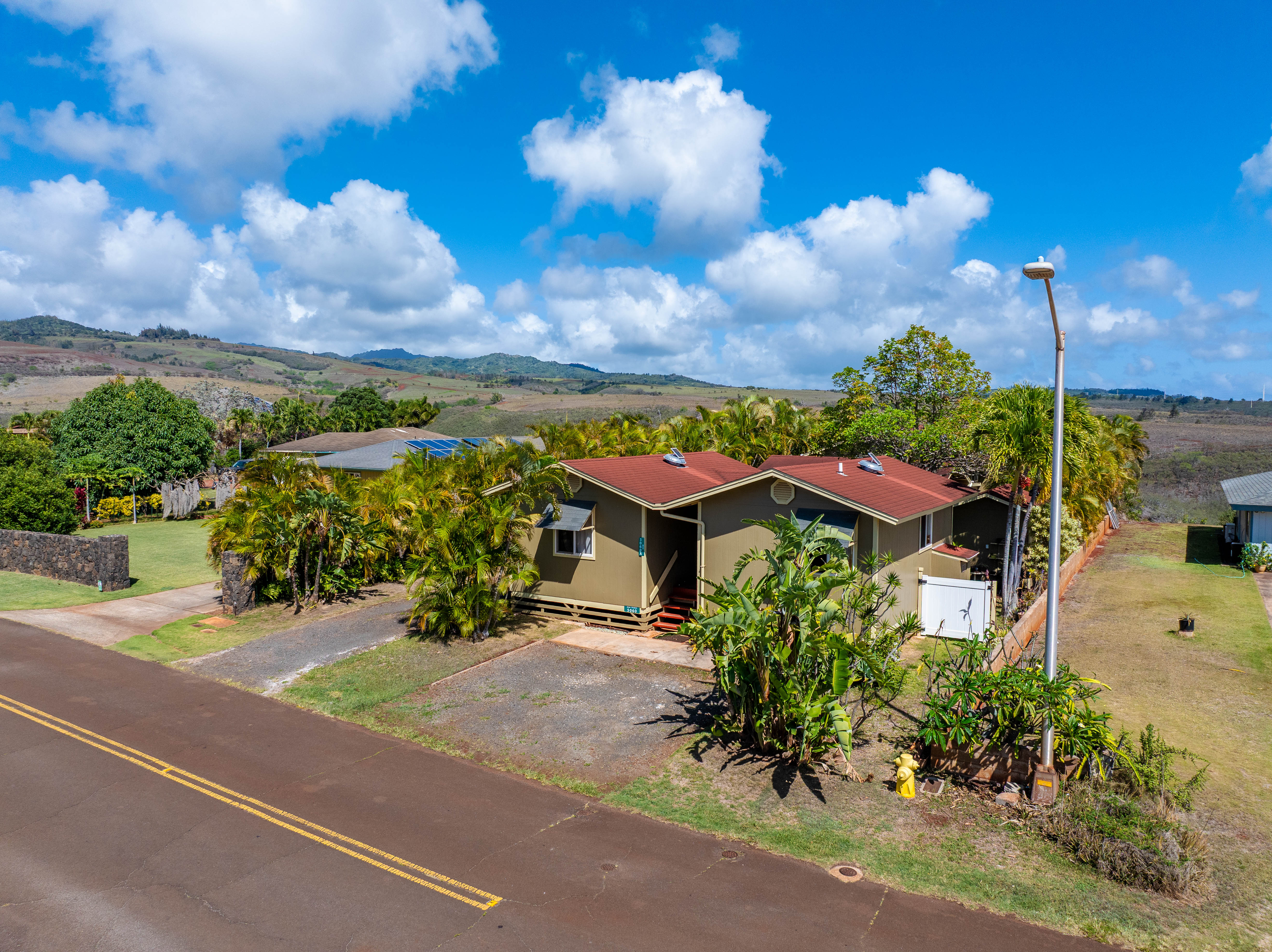 5060 Alii Road Hanapepe, HI 96716 - Photo 4 of 30 a view of a house with a yard and potted plants
