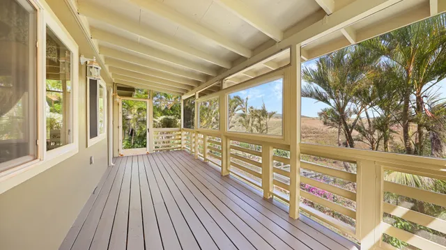a view of a balcony with wooden floor