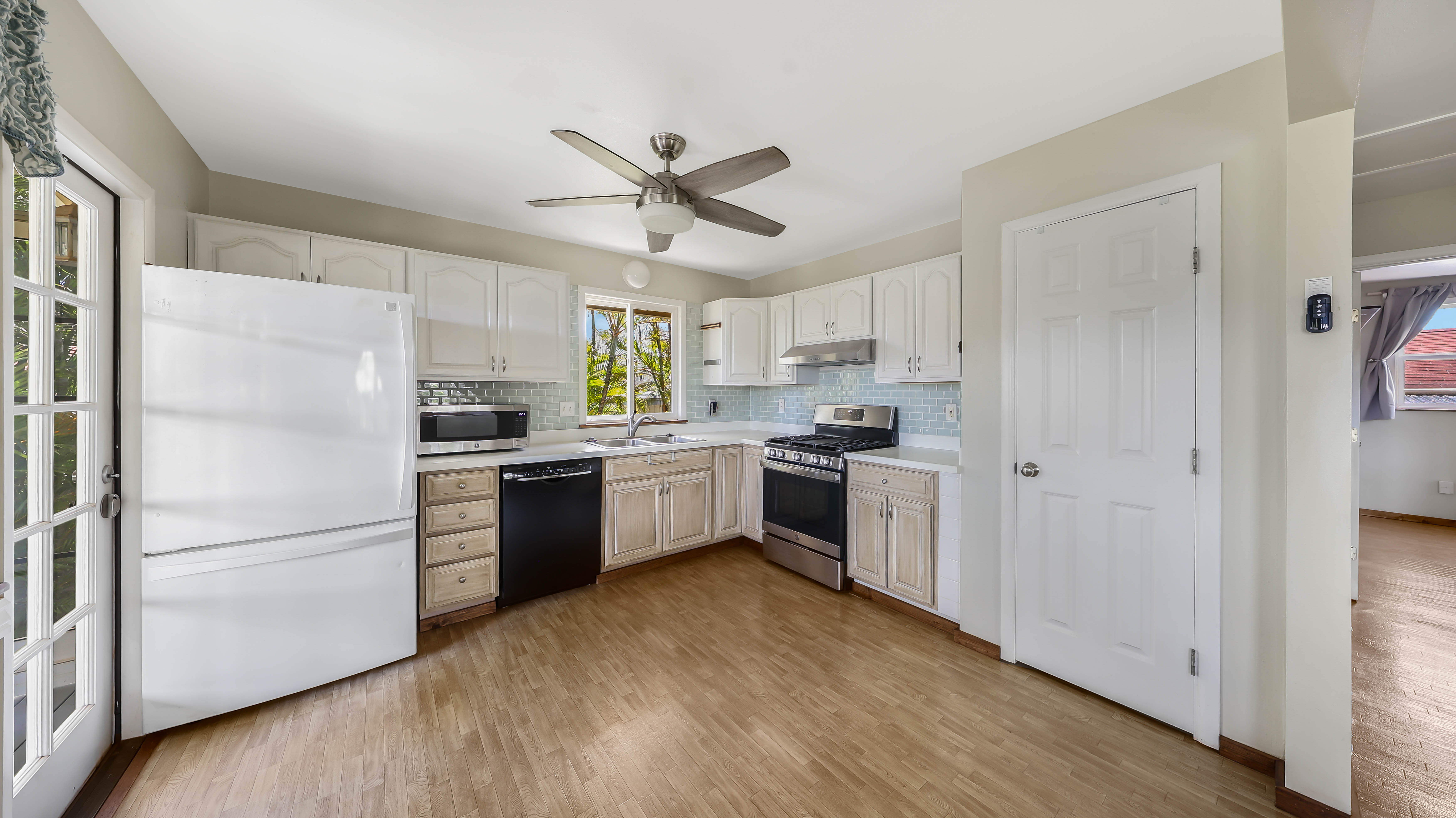 5060 Alii Road Hanapepe, HI 96716 - Photo 10 of 30 a kitchen with a refrigerator a sink stainless steel appliances and cabinets