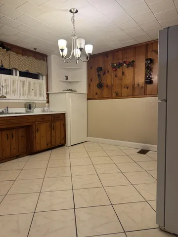 a large kitchen with kitchen island granite countertop a stove a sink and a refrigerator