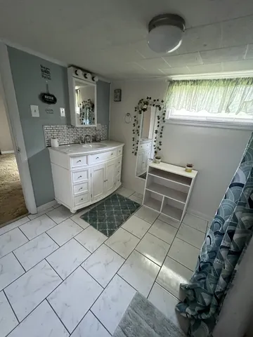 a room with a sink and a mirror