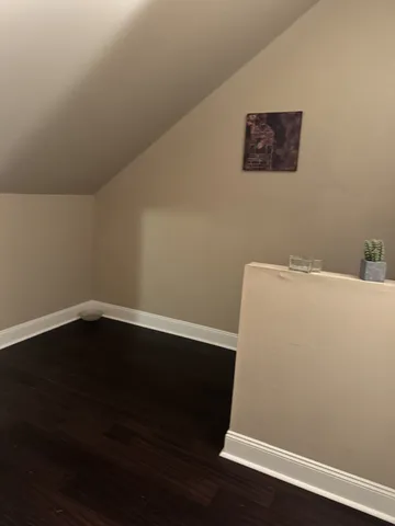 a view of a small space with wooden floor and a window