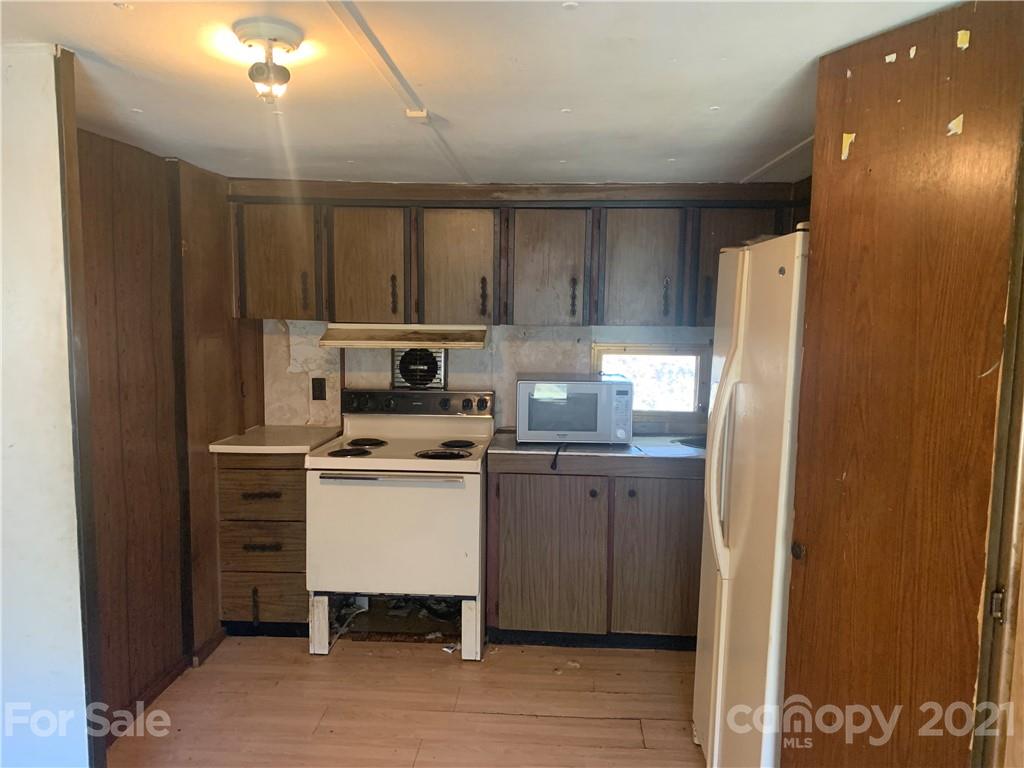 255 Sherrill Road Bryson City, NC 28713 - Photo 6 of 15 a kitchen with a refrigerator a stove a sink and a microwave