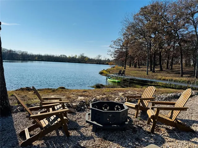 a view of a backyard with sitting area