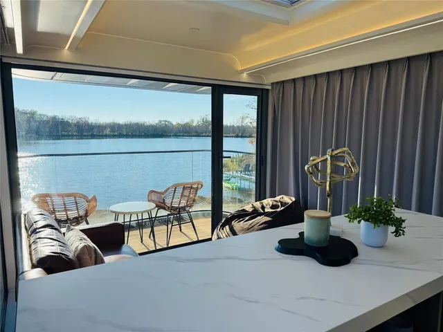 a living room with furniture and floor to ceiling window