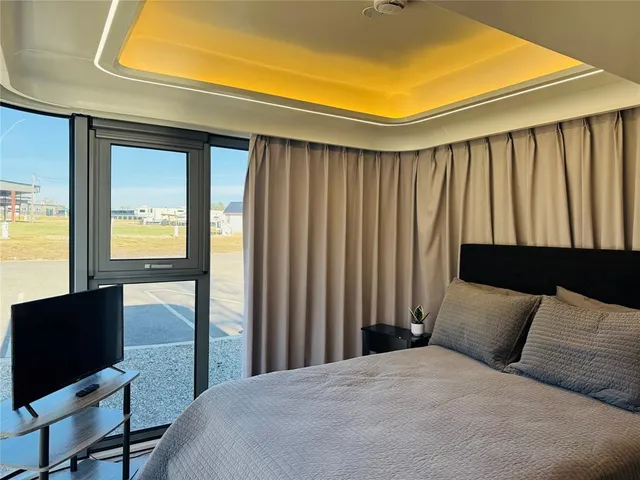 a bed sitting in a bedroom next to a window