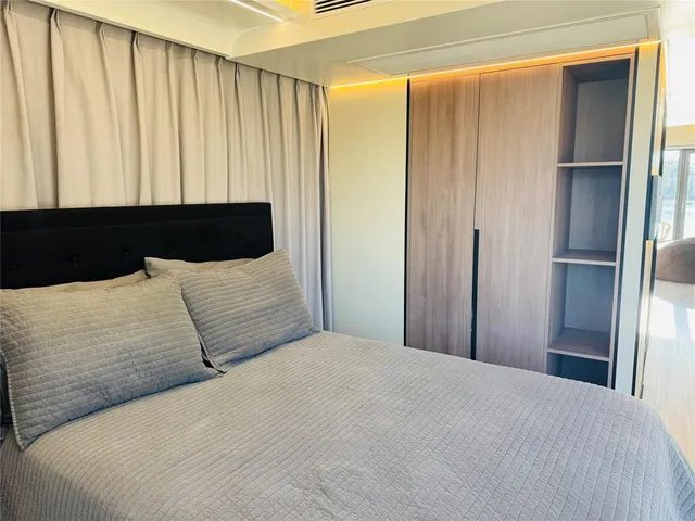 a bedroom with a large bed and a window