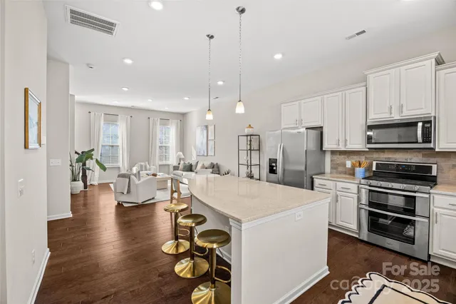 a large kitchen with a table and chairs