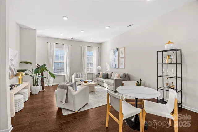 a living room with furniture a rug and a table