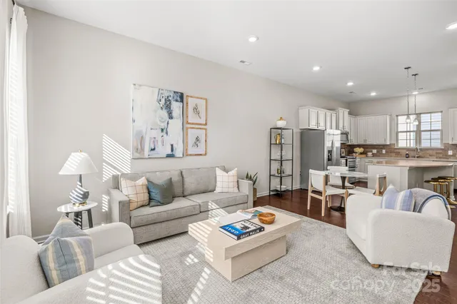 a living room with furniture kitchen and a table