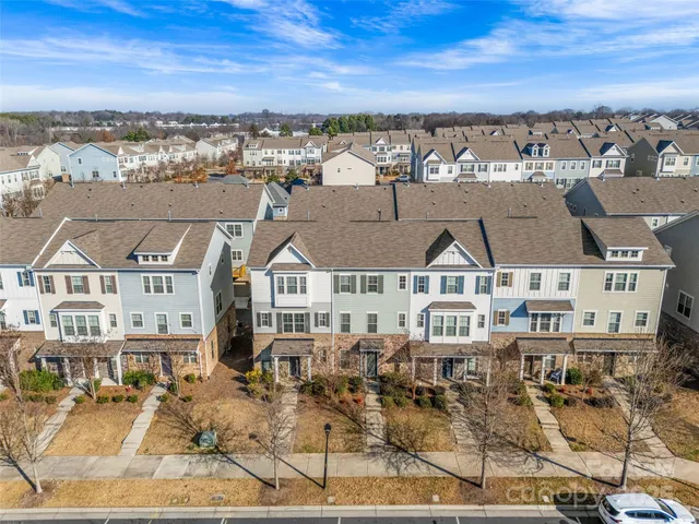 a front view of a house with large trees