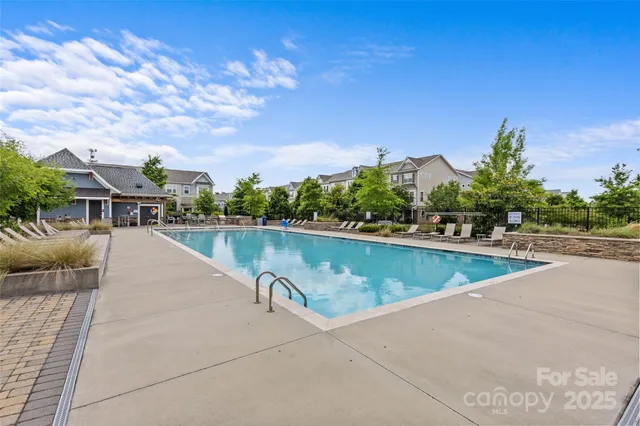 a view of a patio with couches table and chairs and potted plants