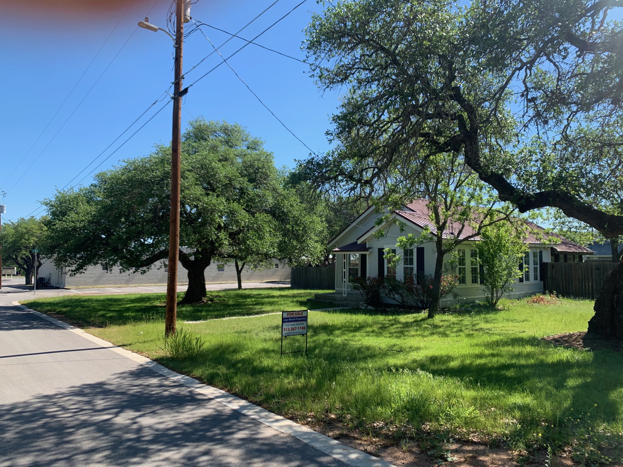 435 North Street Bertram, TX 78605 - Photo 2 of 14 a view of house in front of a big yard with large trees